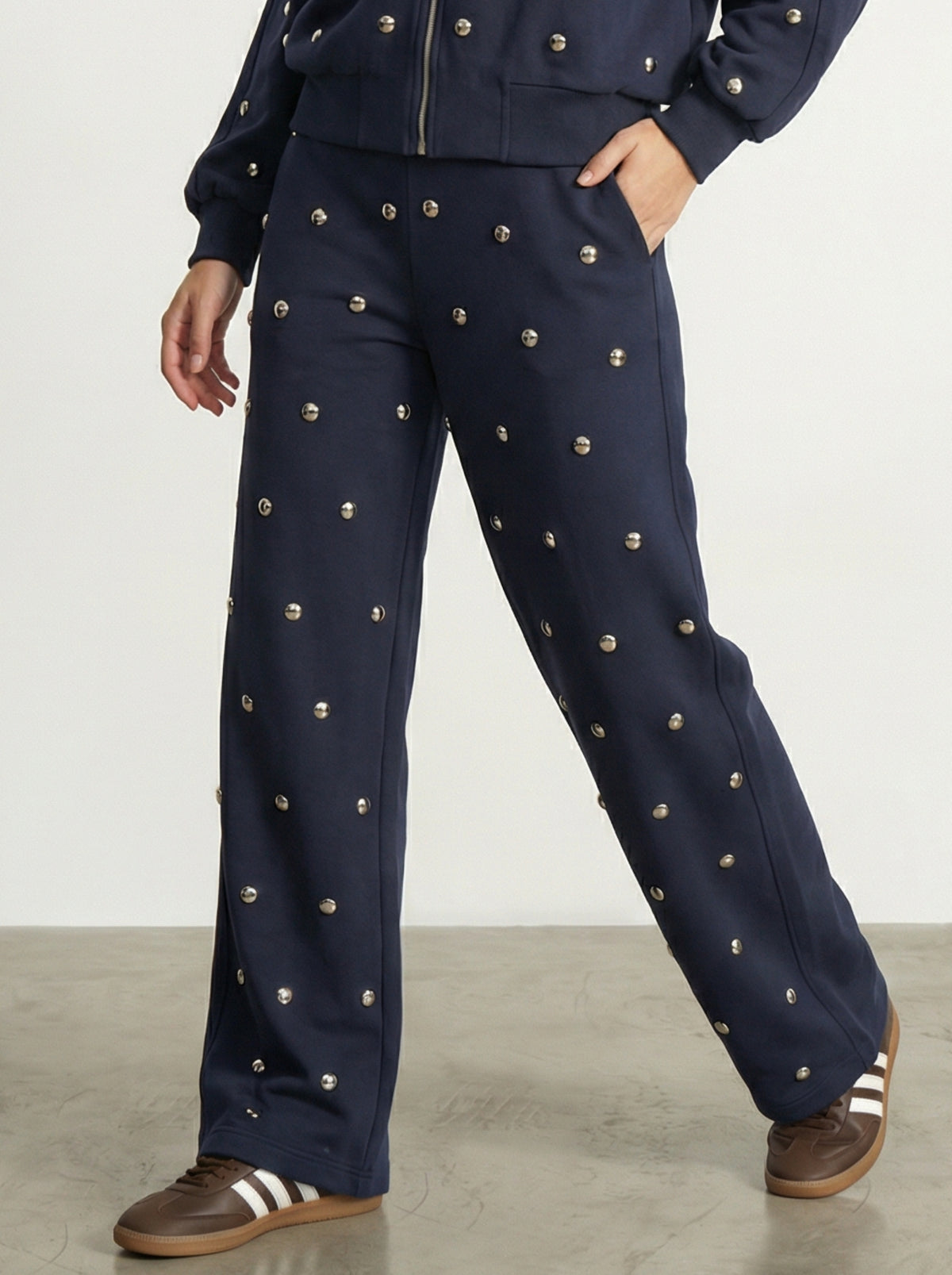 PANTALONE CON BORCHIE ALL-OVER